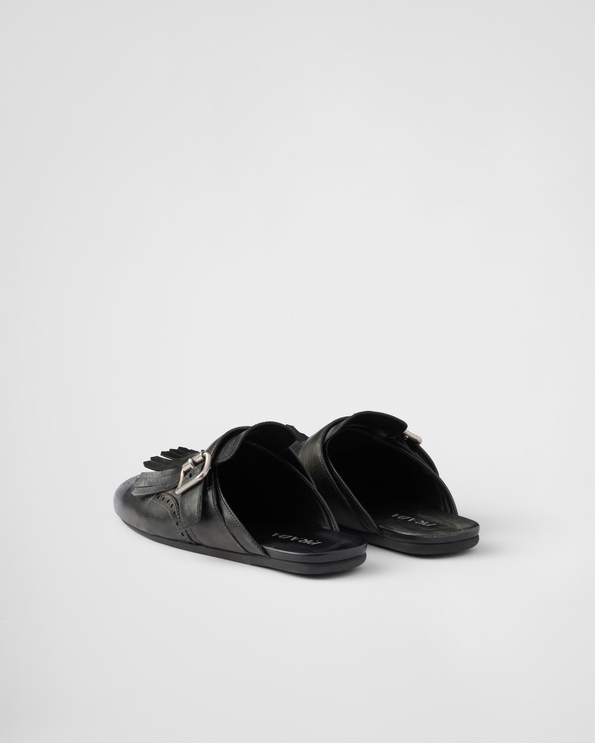 Prada Mules Shuffle de piel con flecos Ventas relámpago