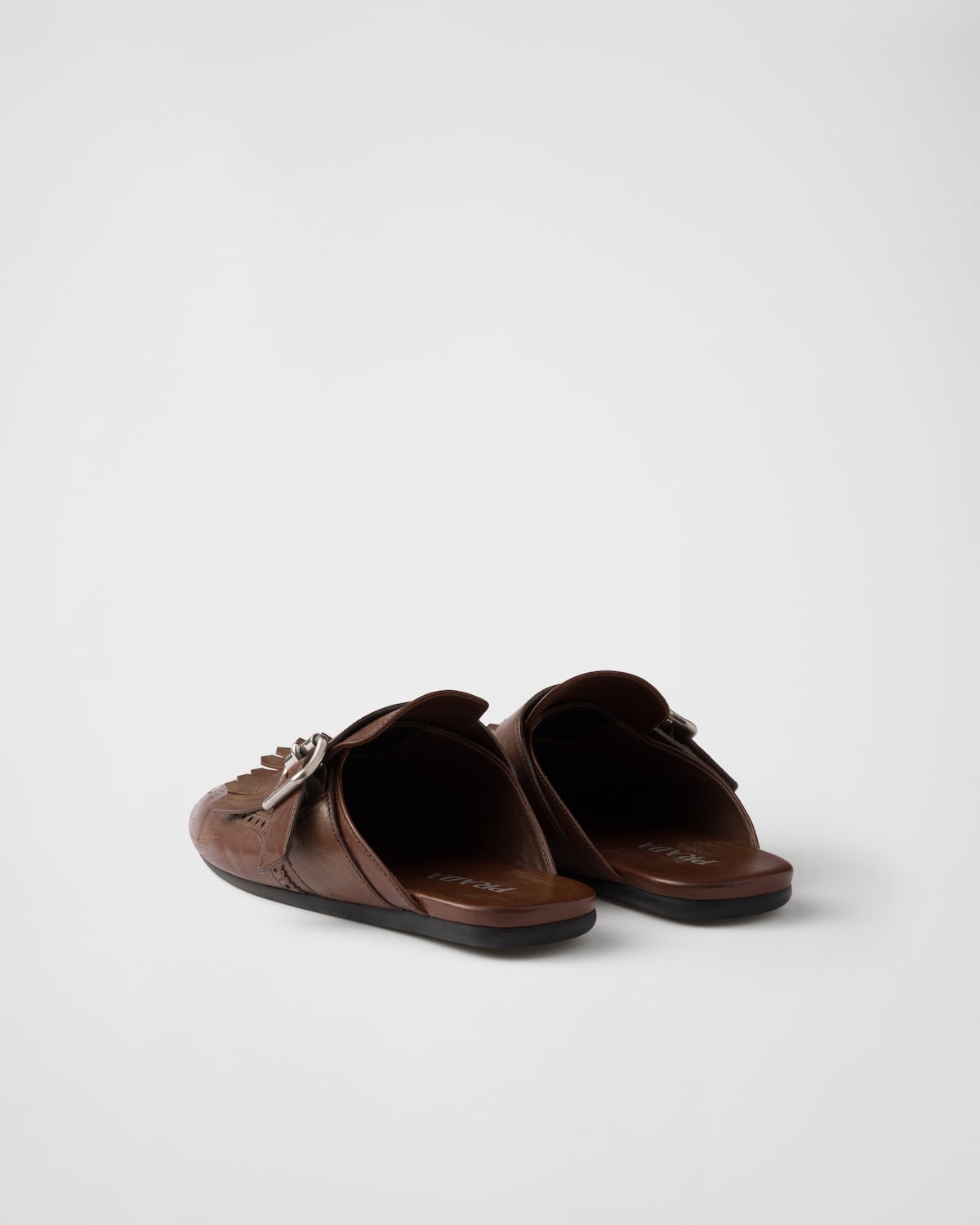 Prada Mules Shuffle de piel con flecos Descuento