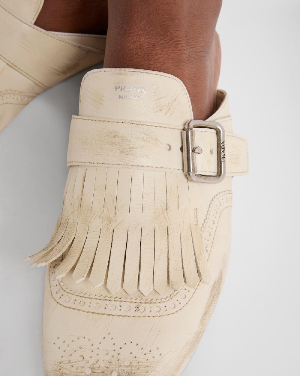 Prada Mules Shuffle de piel con flecos Tienda