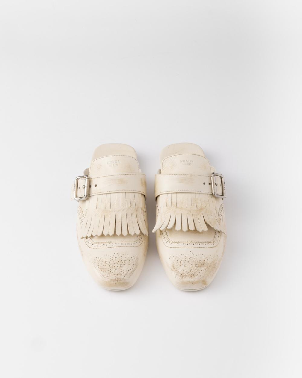 Prada Mules Shuffle de piel con flecos Tienda