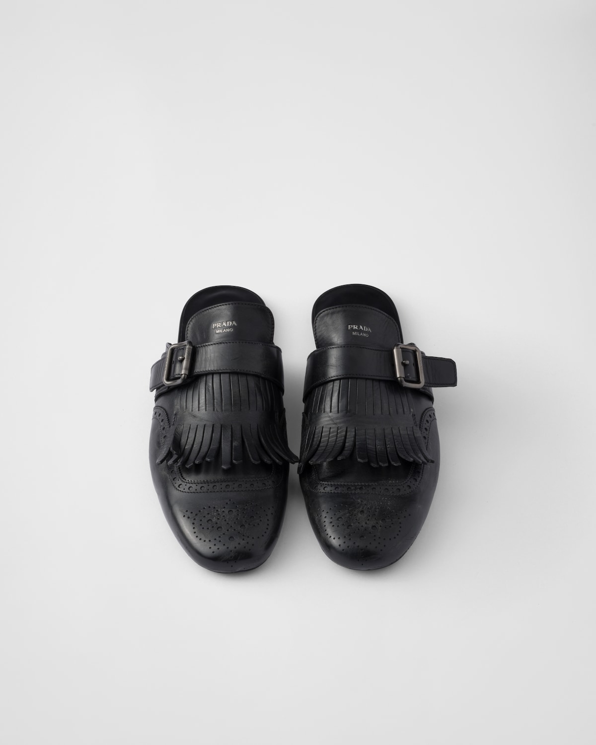 Prada Mules Shuffle de piel con flecos y correa de hebilla Ofertas especiales