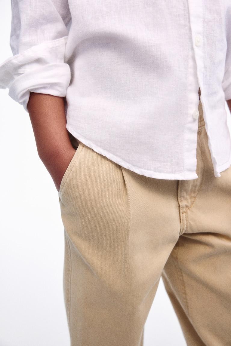 H&M Chinos pitillo de corte holgado en sarga - Beige - NIÑOS Promoción trimestral