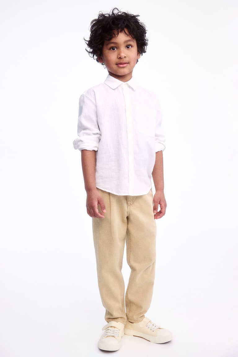 H&M Chinos pitillo de corte holgado en sarga - Gris - NIÑOS